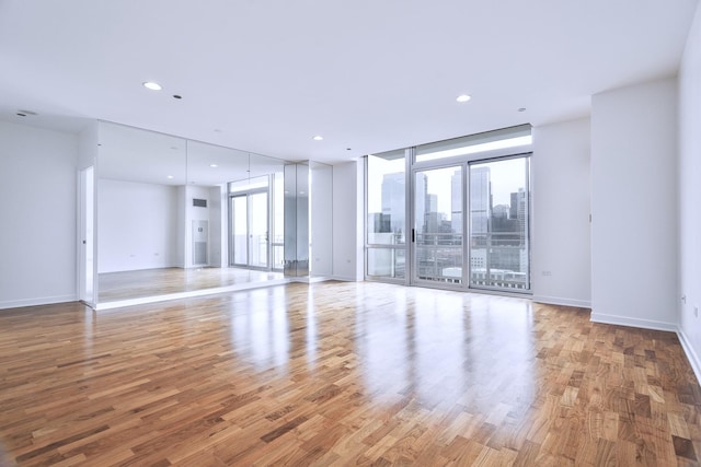 737 W Washington Blvd Unit 2702, Chicago, IL 60661 - spare room with plenty of natural light, wood finished floors, baseboards, recessed lighting, and expansive windows