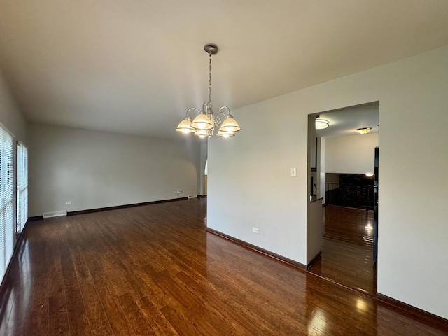 18013 Park Ave, Lansing, IL 60438 - spare room featuring wood finished floors, a chandelier, and baseboards