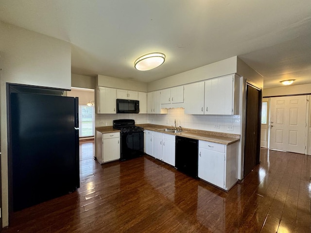 18013 Park Ave, Lansing, IL 60438 - kitchen featuring black appliances, a sink, dark wood-style floors, white cabinets, and tasteful backsplash