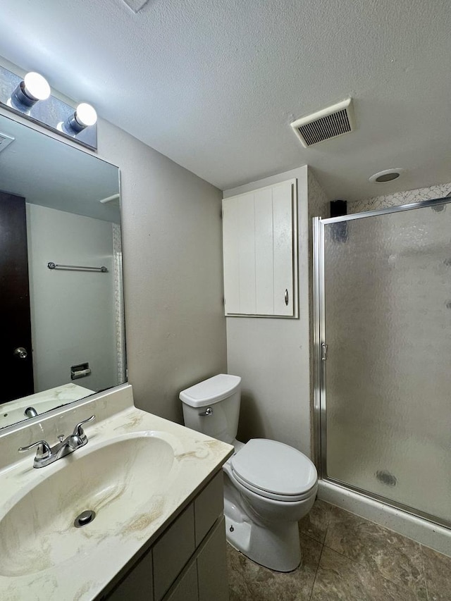 18013 Park Ave, Lansing, IL 60438 - bathroom with a textured ceiling, a shower stall, vanity, toilet, and tile patterned floors