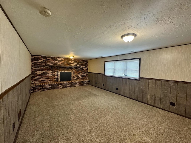 18013 Park Ave, Lansing, IL 60438 - unfurnished living room with wainscoting, a brick fireplace, a textured ceiling, carpet floors, and wood walls