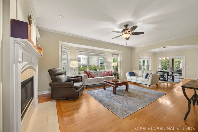 203 E Lincoln Ave, Wheaton, IL 60187 - living room with a fireplace, a chandelier, ceiling fan, light wood-style floors, and crown molding