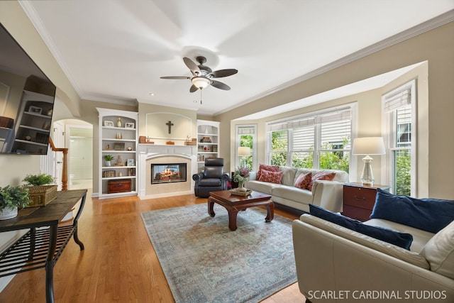 203 E Lincoln Ave, Wheaton, IL 60187 - living area with ceiling fan, a glass covered fireplace, light wood-style floors, ornamental molding, and built in shelves