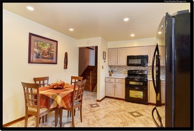 510 W Millns Ct, Addison, IL 60101 - kitchen featuring black appliances, light countertops, light marble finish floors, backsplash, and recessed lighting