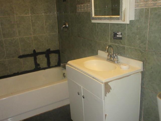 2311 N Natchez Ave, Chicago, IL 60707 - full bathroom featuring tile walls and vanity