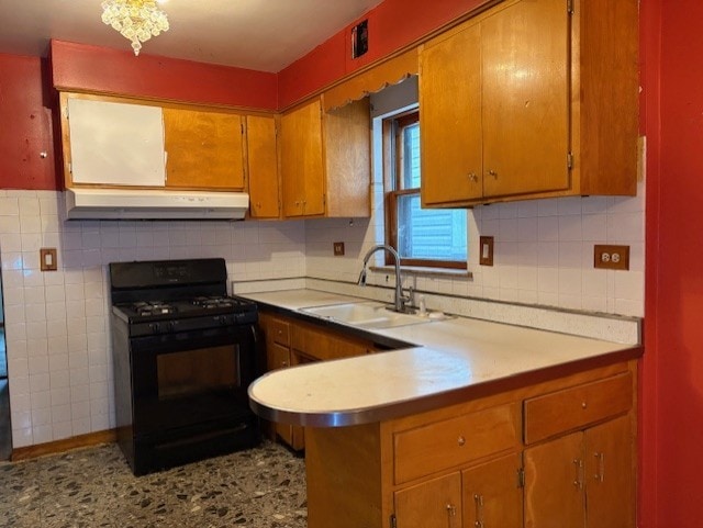 2311 N Natchez Ave, Chicago, IL 60707 - kitchen featuring black gas stove, under cabinet range hood, a sink, light countertops, and a peninsula