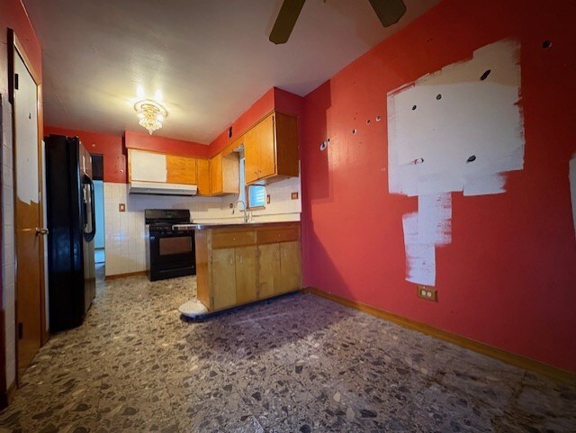 2311 N Natchez Ave, Chicago, IL 60707 - kitchen featuring range, freestanding refrigerator, under cabinet range hood, a ceiling fan, and a peninsula