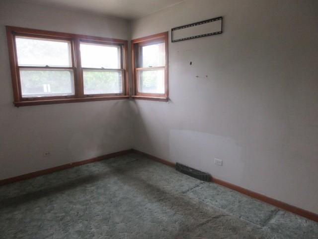 2311 N Natchez Ave, Chicago, IL 60707 - carpeted empty room with baseboards