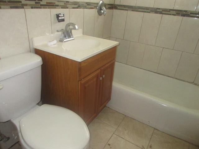 2311 N Natchez Ave, Chicago, IL 60707 - bathroom with toilet, vanity, tile patterned flooring, tile walls, and washtub / shower combination