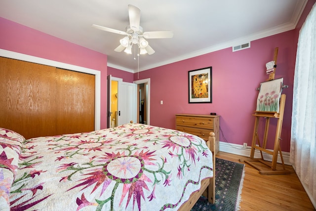 3300 Grove Ave Unit 3S, Berwyn, IL 60402 - bedroom featuring a closet, a baseboard heating unit, wood finished floors, a ceiling fan, and crown molding