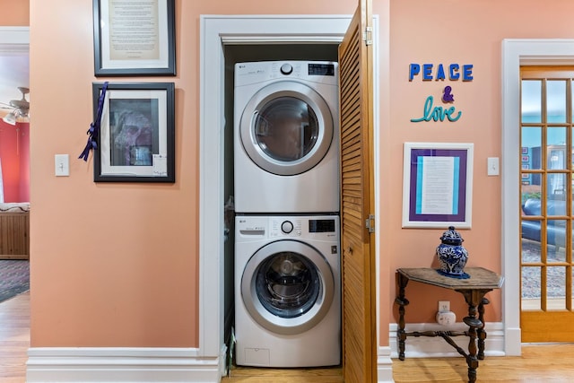 3300 Grove Ave Unit 3S, Berwyn, IL 60402 - laundry area with stacked washer and clothes dryer, wood finished floors, and baseboards