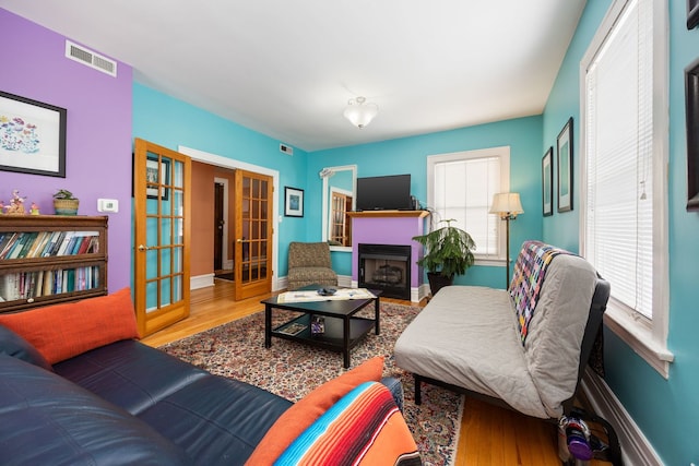 3300 Grove Ave Unit 3S, Berwyn, IL 60402 - living area with wood finished floors, french doors, baseboards, and a fireplace