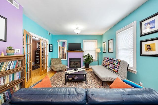 3300 Grove Ave Unit 3S, Berwyn, IL 60402 - living room with french doors, wood finished floors, a fireplace, and baseboards