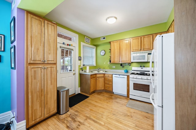 3300 Grove Ave Unit 3S, Berwyn, IL 60402 - kitchen featuring white appliances, a sink, light wood-style flooring, and light countertops