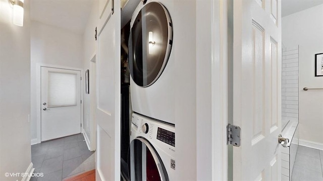 1508 Elmwood Ave Unit 3, Evanston, IL 60201 - washroom with stacked washer / dryer, tile patterned floors, and baseboards