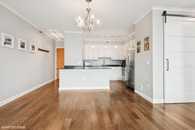 421 W Huron St Unit 1503, Chicago, IL 60654 - kitchen with freestanding refrigerator, crown molding, dark countertops, a sink, and a chandelier