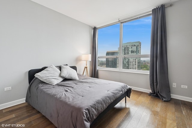 421 W Huron St Unit 1503, Chicago, IL 60654 - bedroom featuring baseboards, wood-type flooring, and a view of city