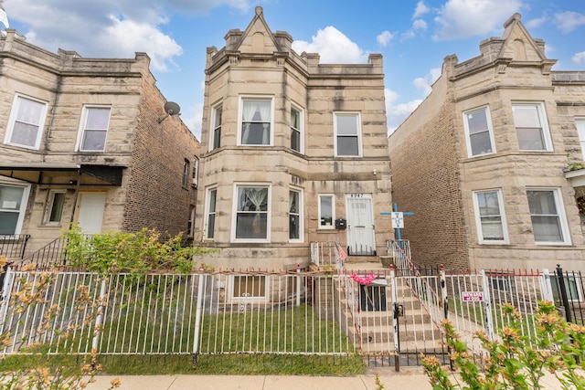 4947 W Huron St, Chicago, IL 60644 - view of front facade with a fenced front yard and stone siding