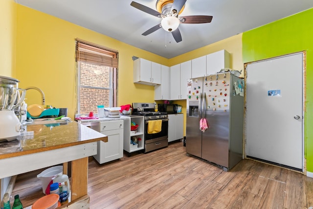 4947 W Huron St, Chicago, IL 60644 - kitchen with appliances with stainless steel finishes, light wood-style floors, white cabinets, and ceiling fan