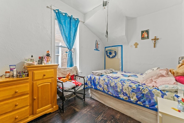 4947 W Huron St, Chicago, IL 60644 - bedroom featuring dark wood-type flooring, vaulted ceiling, and a textured wall