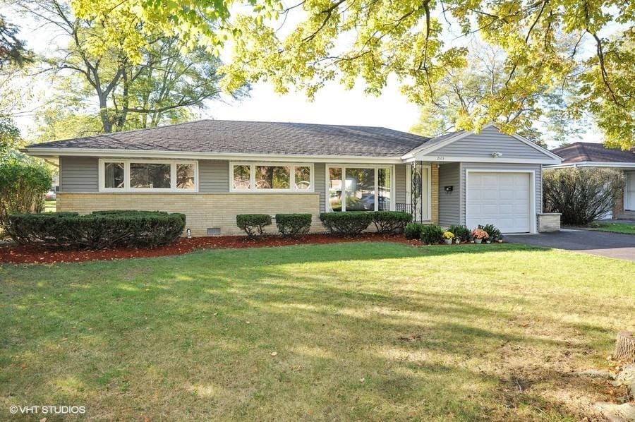 2313 Robincrest Ln, Glenview, IL 60025 - ranch-style home featuring a garage, asphalt driveway, brick siding, and a front yard