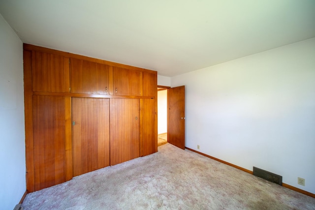 2056 Peek Home Rd, Dixon, IL 61021 - unfurnished bedroom featuring carpet flooring, baseboards, and a closet