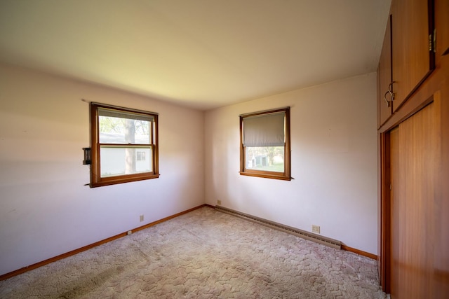2056 Peek Home Rd, Dixon, IL 61021 - spare room featuring light colored carpet, baseboard heating, and baseboards