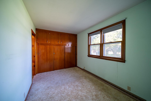2056 Peek Home Rd, Dixon, IL 61021 - unfurnished bedroom featuring a closet, light carpet, and baseboards