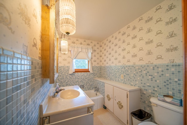 2056 Peek Home Rd, Dixon, IL 61021 - bathroom featuring wallpapered walls, tile walls, toilet, vanity, and wainscoting