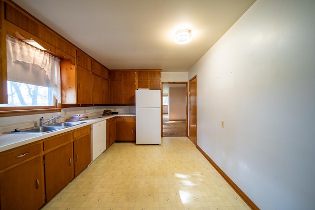 2056 Peek Home Rd, Dixon, IL 61021 - kitchen featuring white appliances, a sink, light floors, light countertops, and brown cabinets