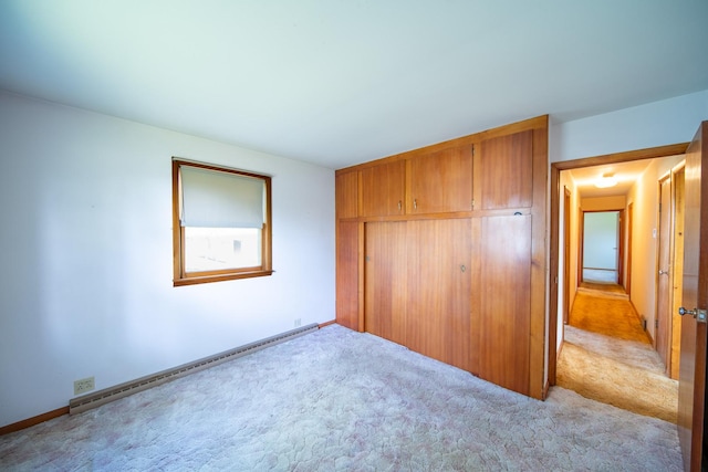 2056 Peek Home Rd, Dixon, IL 61021 - unfurnished bedroom with a baseboard heating unit, light carpet, and baseboards