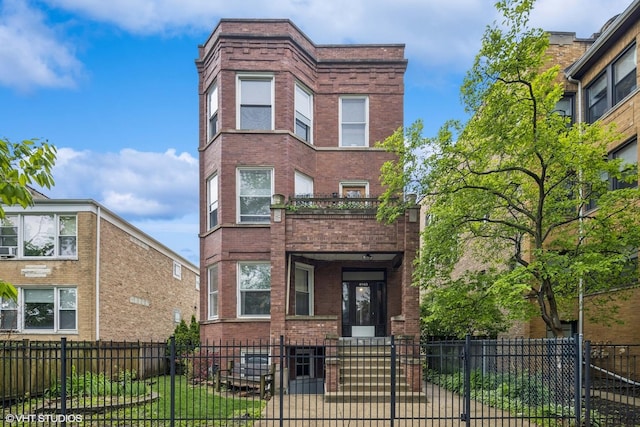 4940 N Ridgeway Ave Unit 3, Chicago, IL 60625 - view of front of property with brick siding, a fenced front yard, and a gate