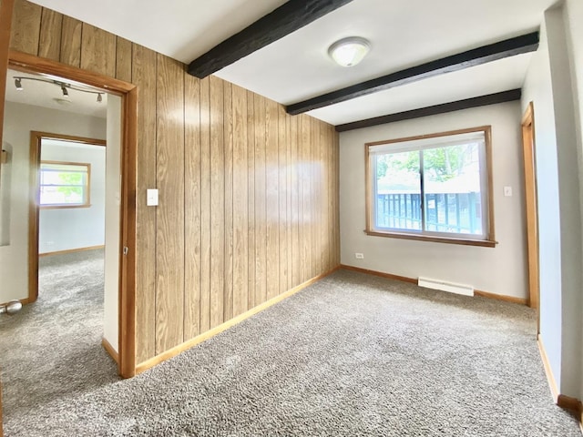 664 E 163rd St, South Holland, IL 60473 - unfurnished room with wood walls, carpet flooring, plenty of natural light, beamed ceiling, and baseboards