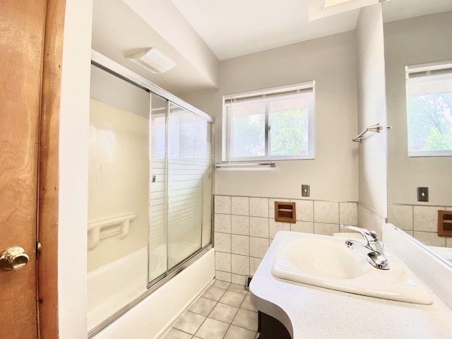 664 E 163rd St, South Holland, IL 60473 - full bathroom with tile patterned flooring, plenty of natural light, tile walls, shower / bath combination with glass door, and vanity
