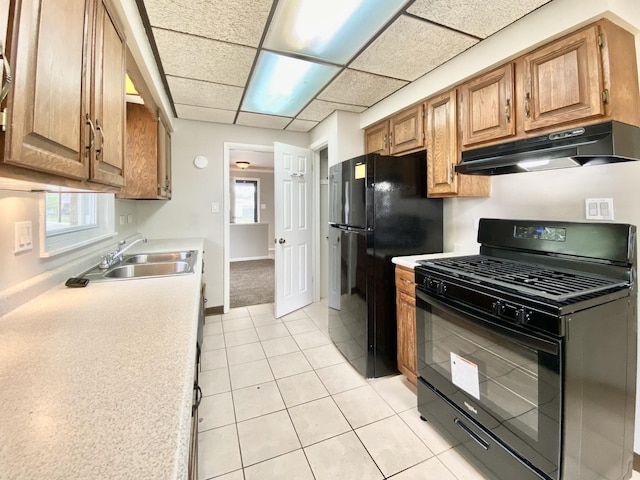 664 E 163rd St, South Holland, IL 60473 - kitchen with black appliances, under cabinet range hood, light countertops, a sink, and plenty of natural light