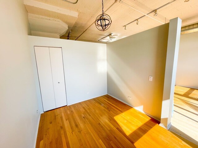 1530 S State St Unit 525, Chicago, IL 60605 - unfurnished room featuring hardwood / wood-style flooring, rail lighting, and baseboards