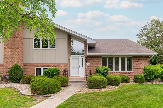 18207 Ohio Ct, Orland Park, IL 60467 - tri-level home with brick siding, a front yard, and roof with shingles
