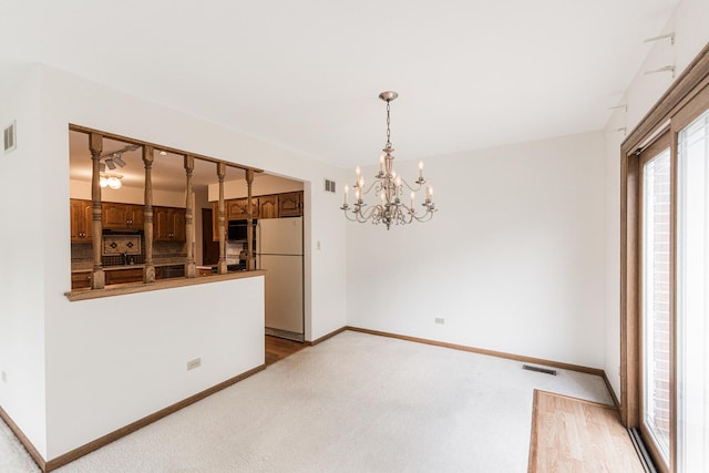 18207 Ohio Ct, Orland Park, IL 60467 - unfurnished dining area featuring a chandelier, baseboards, and light carpet