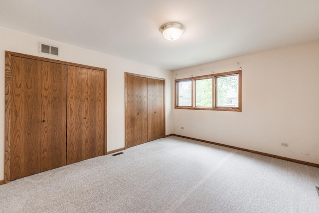 18207 Ohio Ct, Orland Park, IL 60467 - unfurnished bedroom featuring two closets, carpet, and baseboards