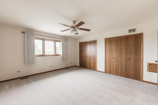 18207 Ohio Ct, Orland Park, IL 60467 - unfurnished bedroom with multiple closets, baseboards, carpet floors, and ceiling fan