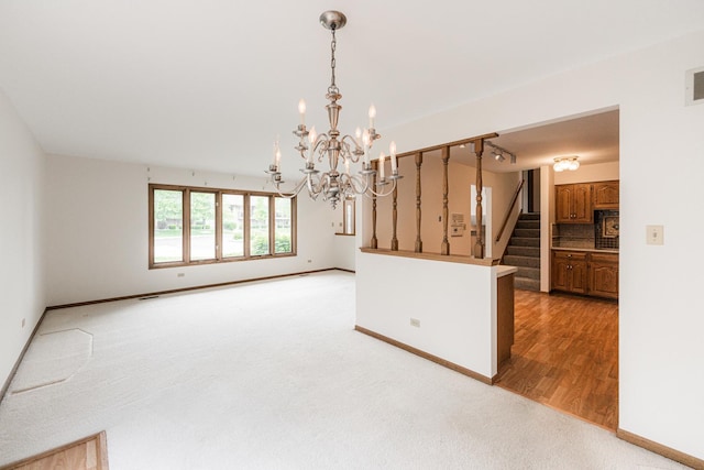 18207 Ohio Ct, Orland Park, IL 60467 - kitchen featuring a chandelier, baseboards, backsplash, hanging light fixtures, and light colored carpet