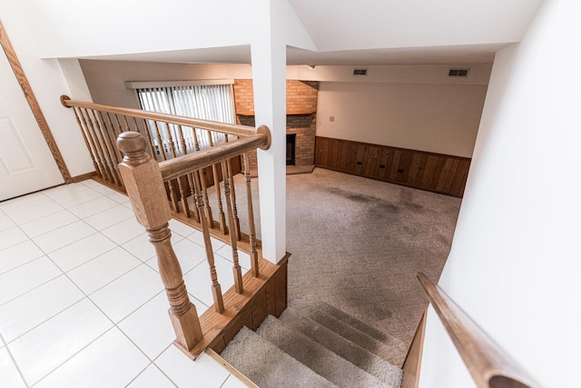 18207 Ohio Ct, Orland Park, IL 60467 - staircase with a brick fireplace, carpet flooring, and wainscoting