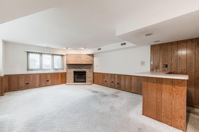 18207 Ohio Ct, Orland Park, IL 60467 - unfurnished living room with wood walls, a wainscoted wall, a fireplace, and light colored carpet