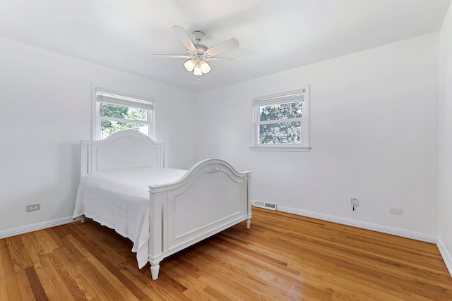128 8th St, Downers Grove, IL 60515 - bedroom with light wood-style floors, baseboards, and a ceiling fan