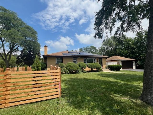 128 8th St, Downers Grove, IL 60515 - view of front of house with roof mounted solar panels, a chimney, and a detached garage