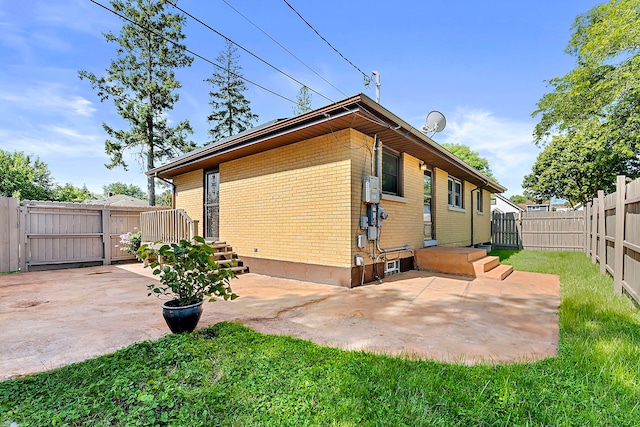 128 8th St, Downers Grove, IL 60515 - back of house featuring brick siding, a gate, a fenced backyard, and a patio