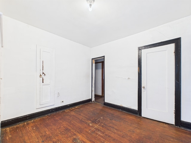 8237 S Ada St, Chicago, IL 60620 - unfurnished bedroom featuring dark wood-style flooring and baseboards