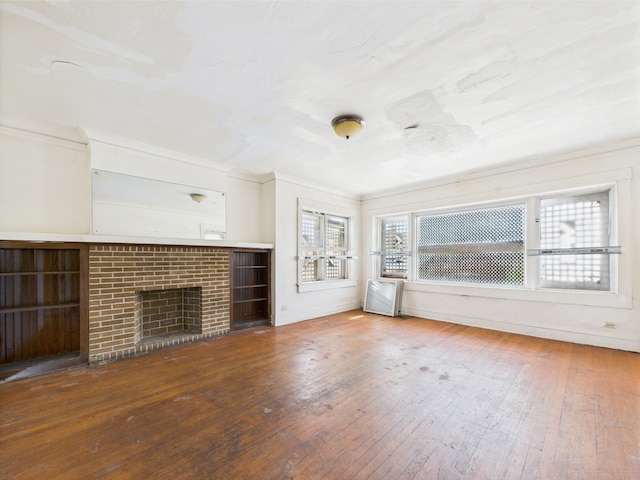 8237 S Ada St, Chicago, IL 60620 - unfurnished living room featuring hardwood / wood-style flooring, a brick fireplace, and ornamental molding