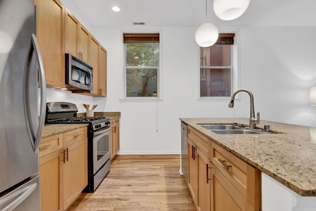 1947 W Evergreen Ave Unit A, Chicago, IL 60622 - kitchen featuring stainless steel appliances, a sink, light wood finished floors, light stone countertops, and recessed lighting