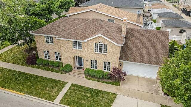 4647 N Thatcher Ave, Norridge, IL 60706 - colonial home featuring a shingled roof, a chimney, concrete driveway, a garage, and a front yard